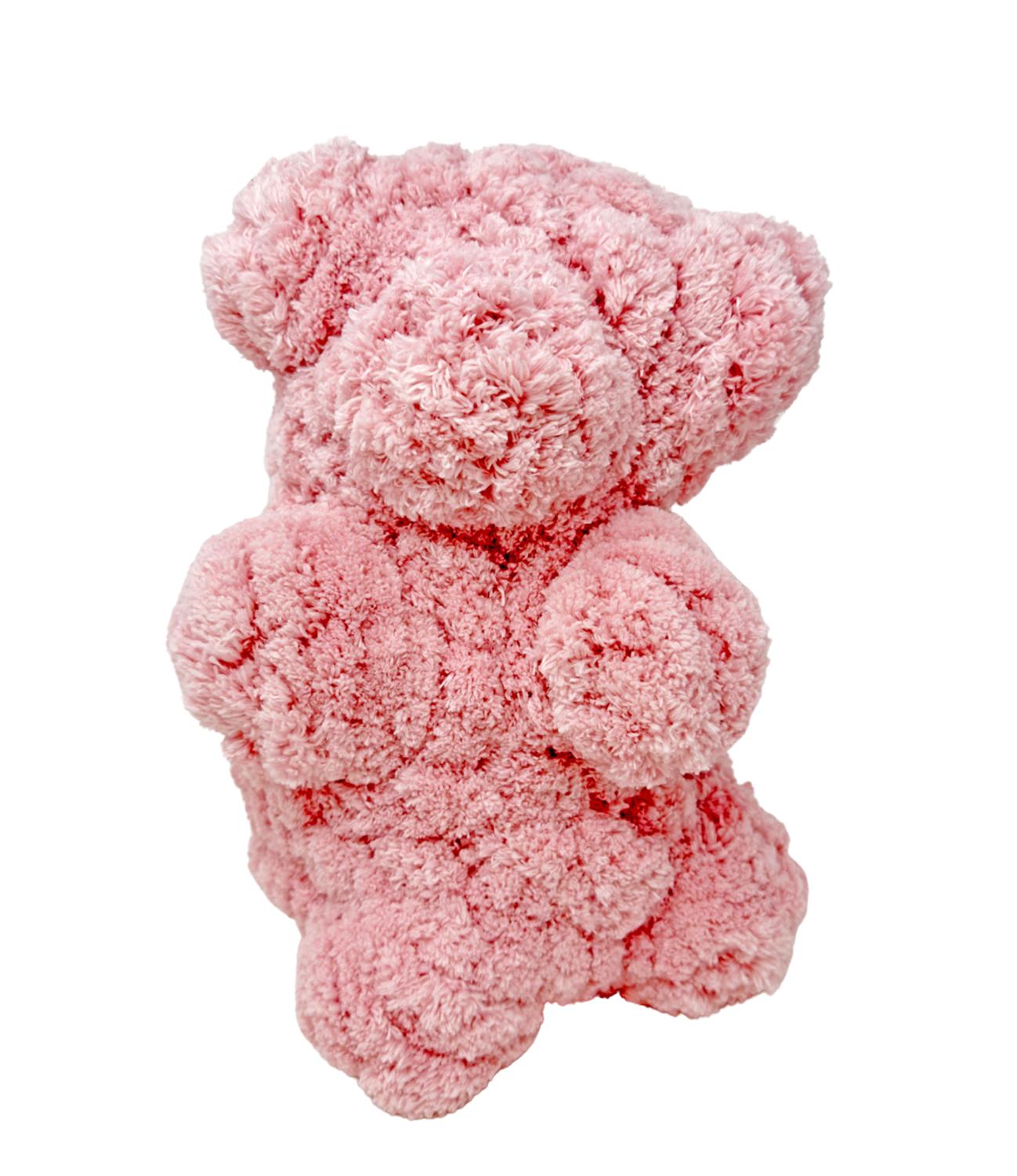 a stuffed pink bear sculpture, made from crocheted yarn. The object is shaped like a large gummy bear, or a classic teddy bear shape with short limbs.
