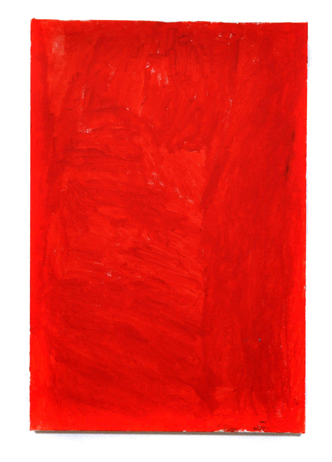 a monochromatic painting on a tall rectangular canvas. the entire surface is covered in a smooth layer of striking bright red paint.