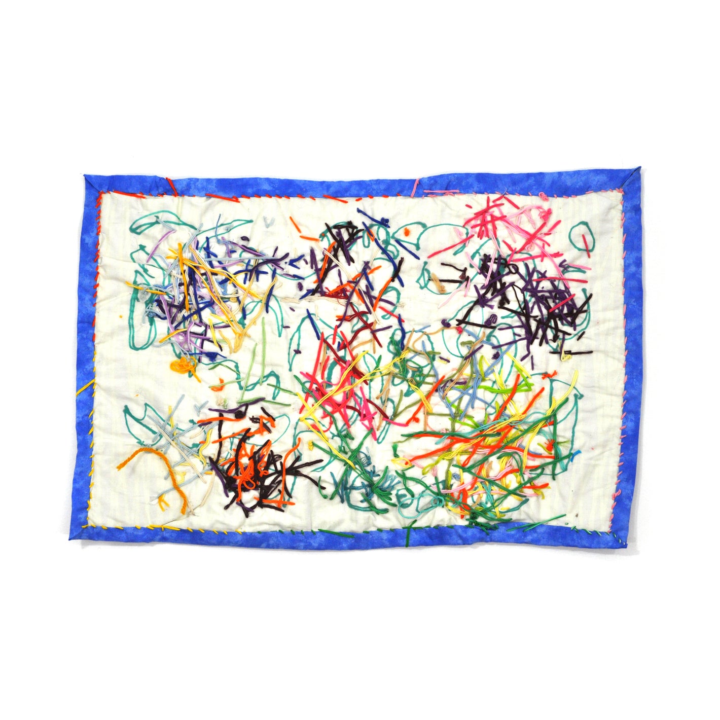 A rectangular fiber work made of a white cloth with a blue border.  The artist has drawn on the fabric with green marker and then embroidered clusters of colorful thread across the entire surface. The blue border is stitched on with a pink and yellow blanket stitch. 